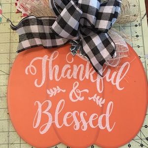 A cute fall pumpkin with a buffalo ribbon.